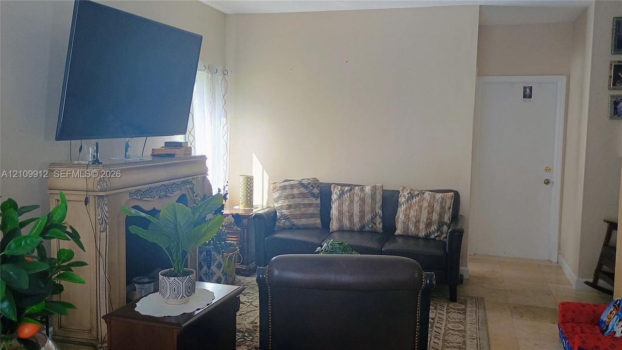 Fireplace featuring decorative molding and stone-tile flooring