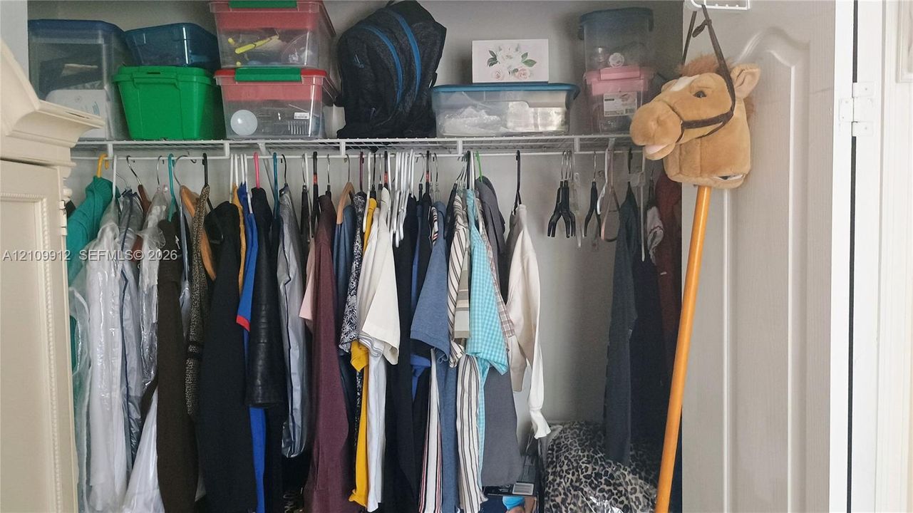 Closet featuring white wire shelving and double-door access
