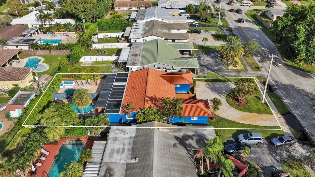 Exceptional duplex featuring two heated pools with supplemental daytime solar heating and a spacious circular driveway accommodating up to six vehicles.