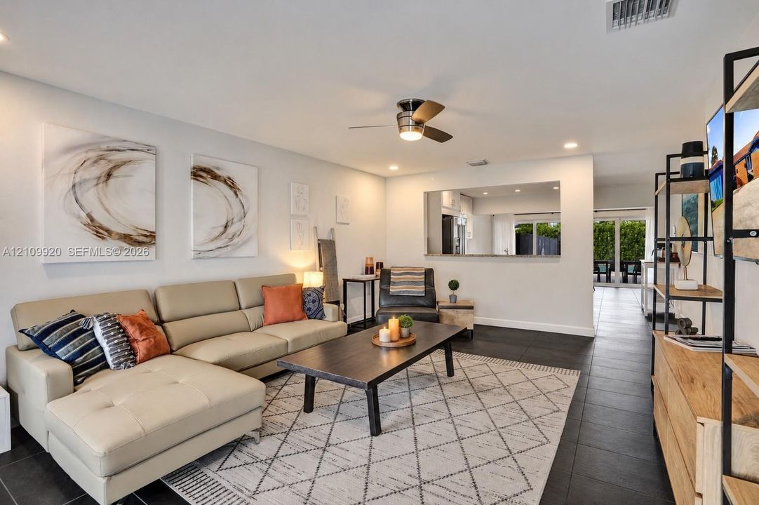 Residence 1753 (Right Side) – Bright, neutral-toned living space, recessed lighting, and open concept floor plan.