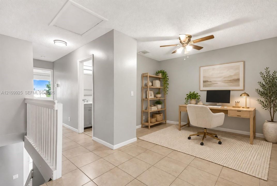 Open-concept space featuring tile flooring, neutral wall paint, and a ceiling fan with integrated lighting