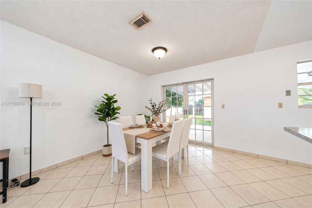 Neutral-toned ceramic tile flooring, dual-panel glass sliding doors with white frames, and flush-mount ceiling lighting