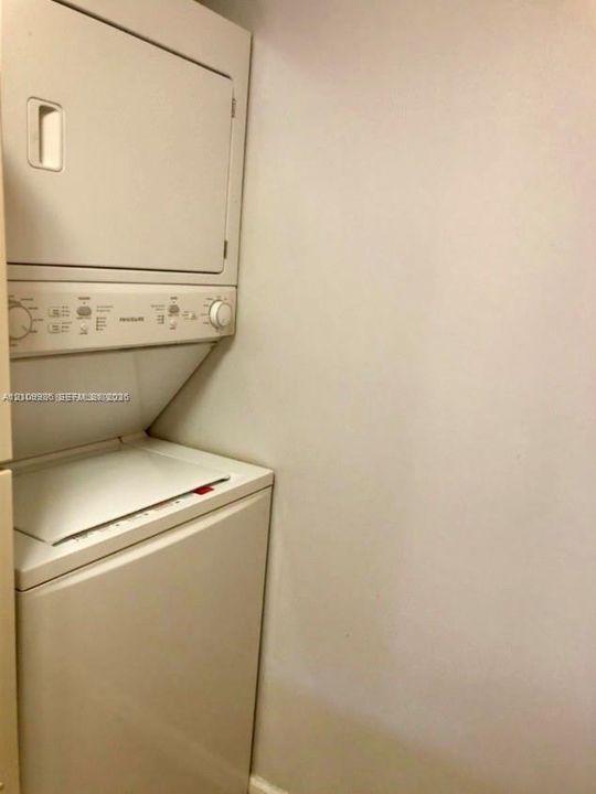 Stackable laundry unit with white finish and integrated dial control panel