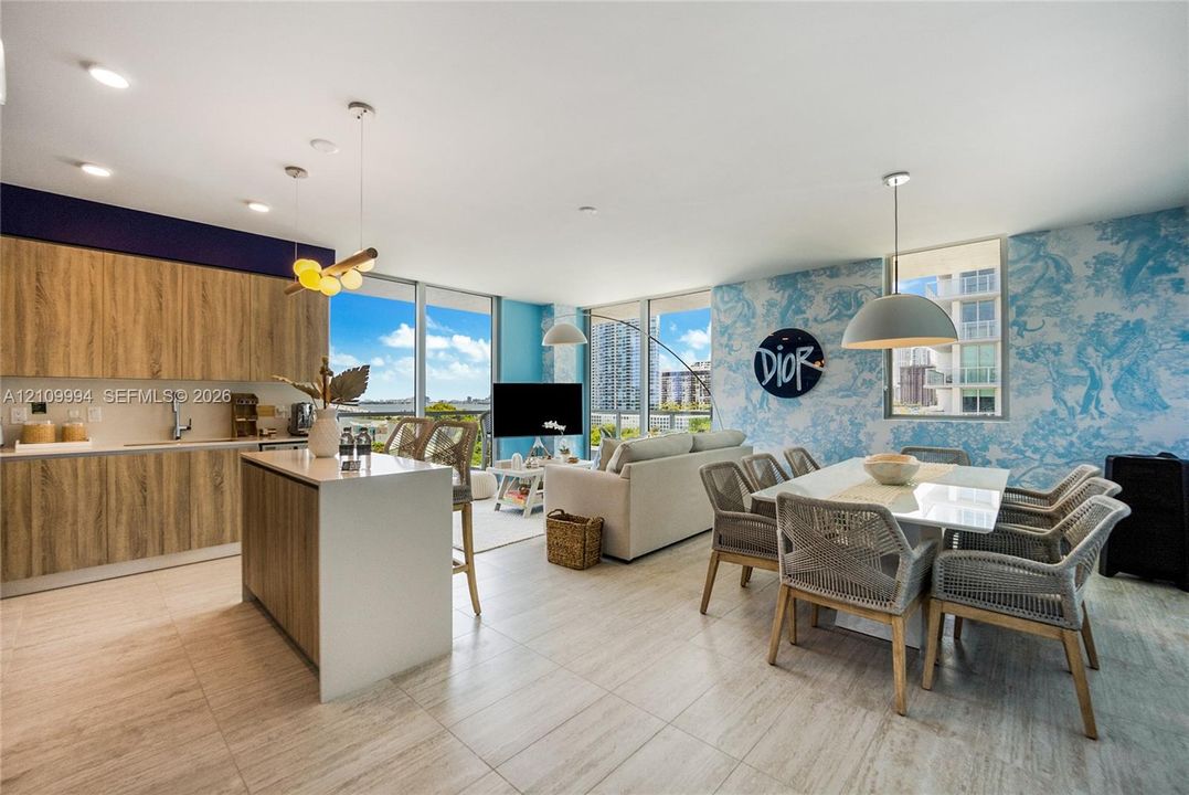 Open-concept interior featuring wood-finish cabinetry, a kitchen island with a stone-finish countertop, tile flooring, floor-to-ceiling windows, and recessed lighting