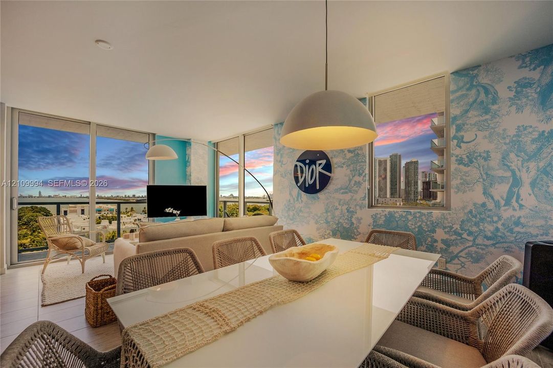 Open-concept living space featuring floor-to-ceiling glass windows, wide-plank tile flooring, and custom wall covering