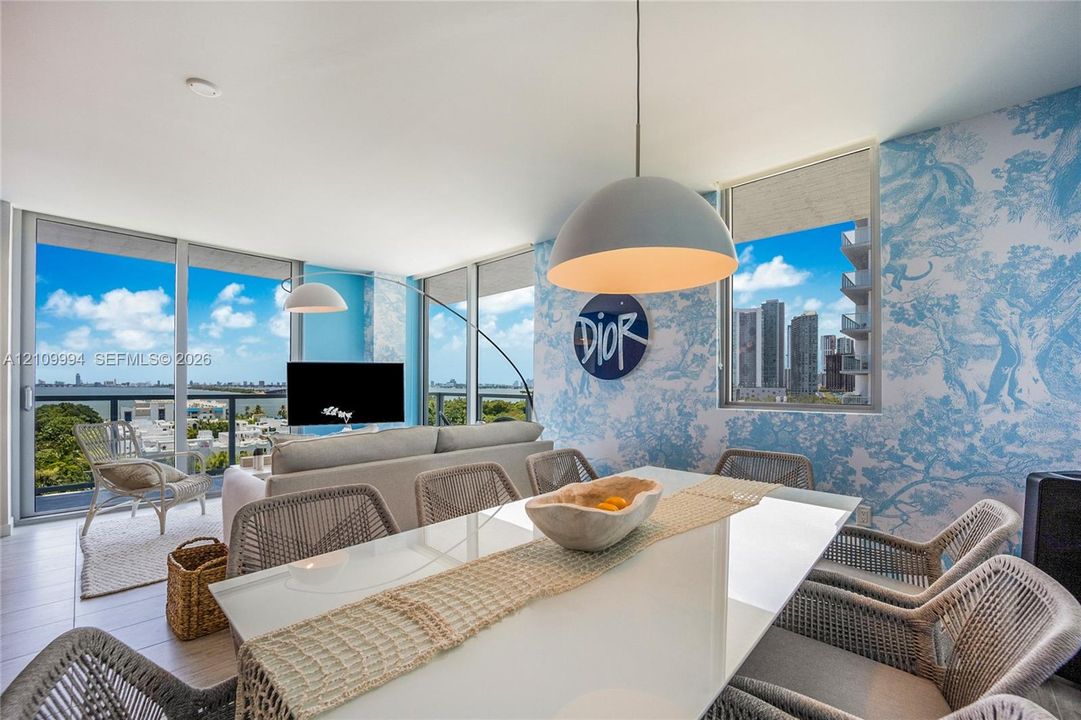 Floor-to-ceiling glass windows, custom patterned wall coverings, matte finish tile flooring, and a dome-shaped pendant light fixture