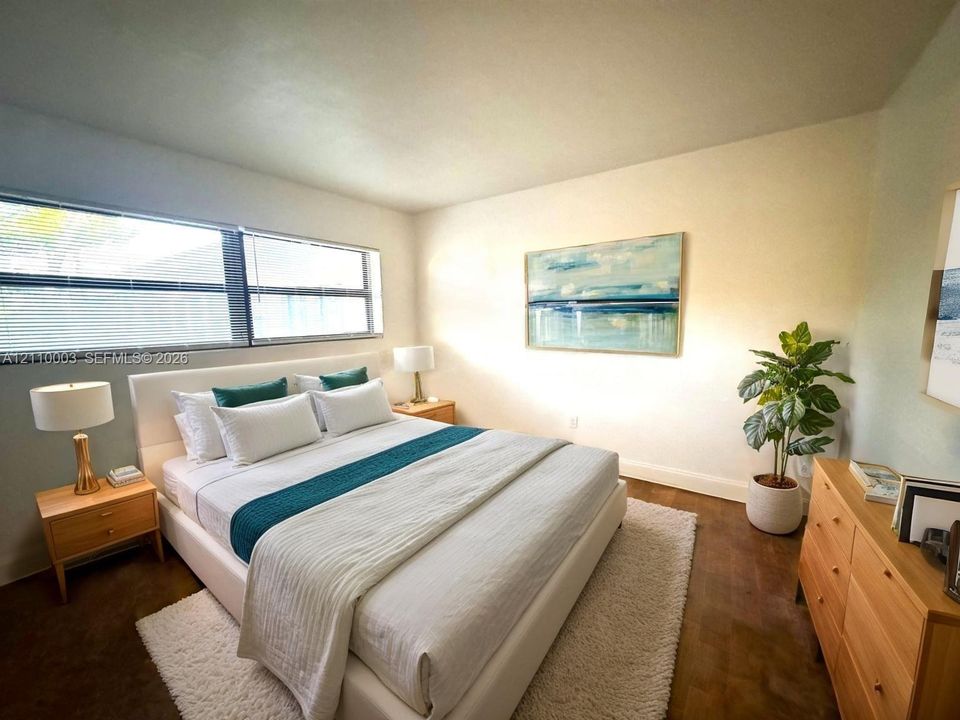 Neutral-toned interior featuring wide-plank wood-finish flooring and large horizontal windows