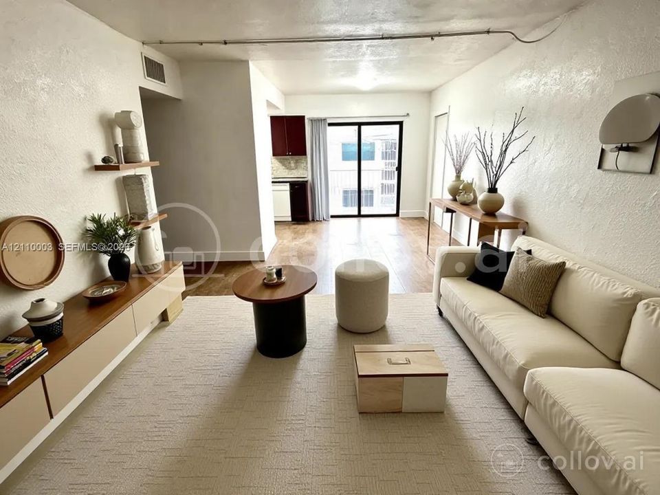 Living area featuring wood-finish flooring, built-in cabinetry, dual wall-mounted shelves, and a sliding glass door providing external access