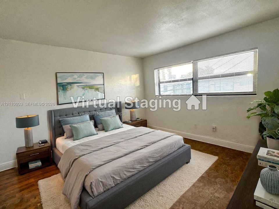 Room featuring light-toned walls, wood-finish flooring, and horizontal windows