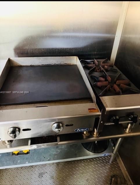 Stainless steel commercial range featuring a flat-top griddle, dual-burner cooktop