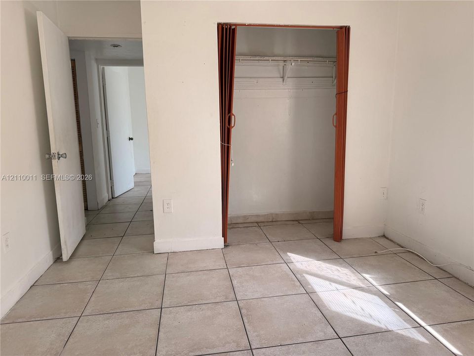 Ceramic tile flooring, closet with accordion door, and solid core interior doors