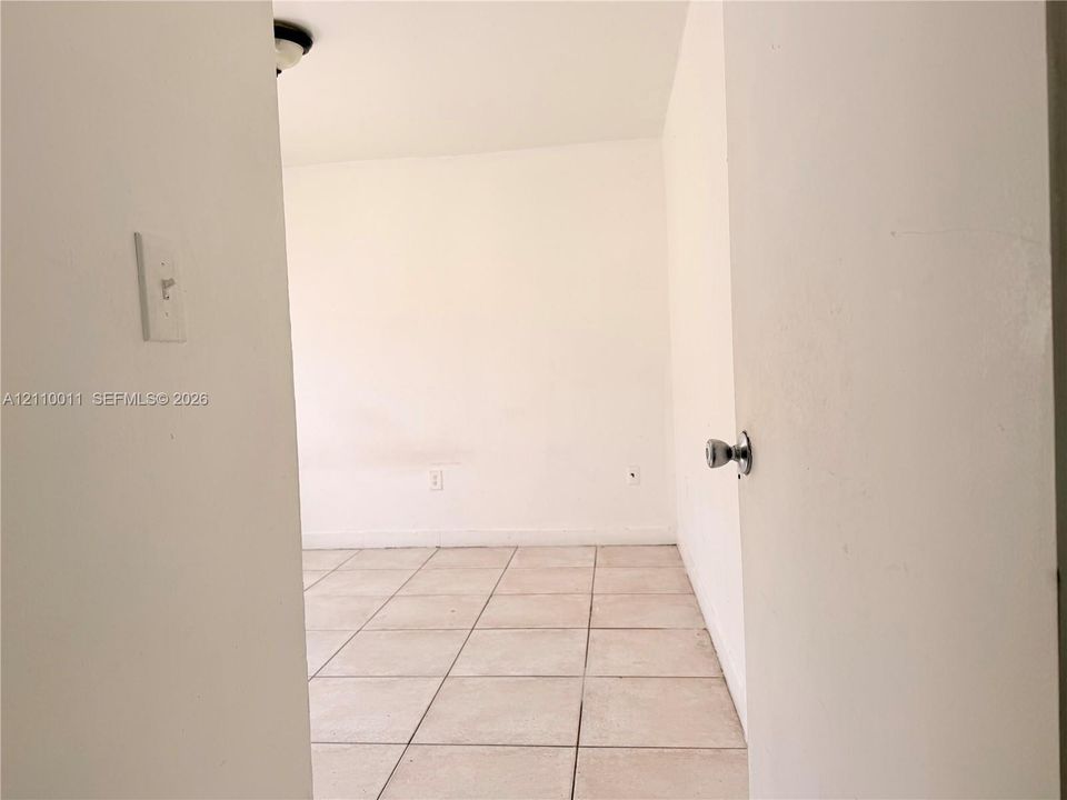Neutral-toned tile flooring and white-painted walls