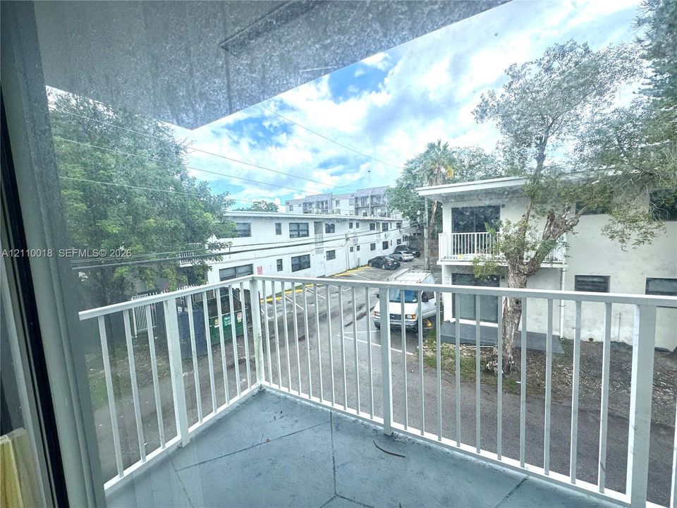 Private balcony featuring a concrete floor and white metal railing