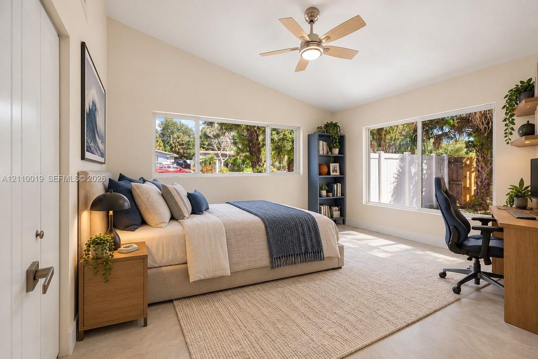 Vaulted ceilings, large picture windows, and a ceiling fan with integrated lighting