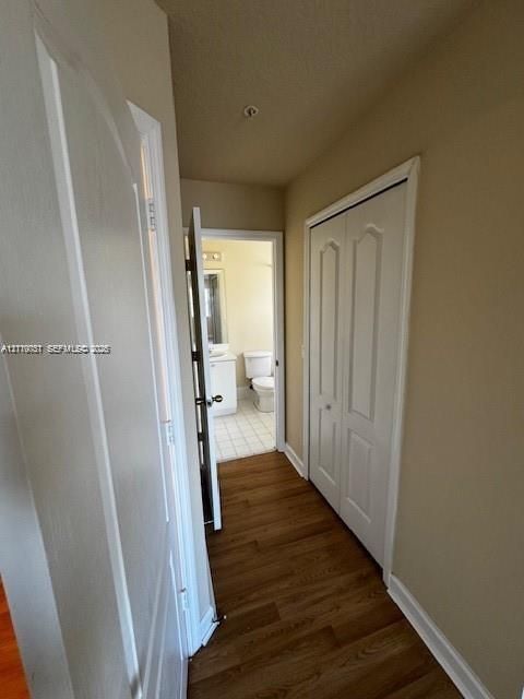 Wood-finish flooring, dual-panel closet doors, and interior passage doors with metal hardware