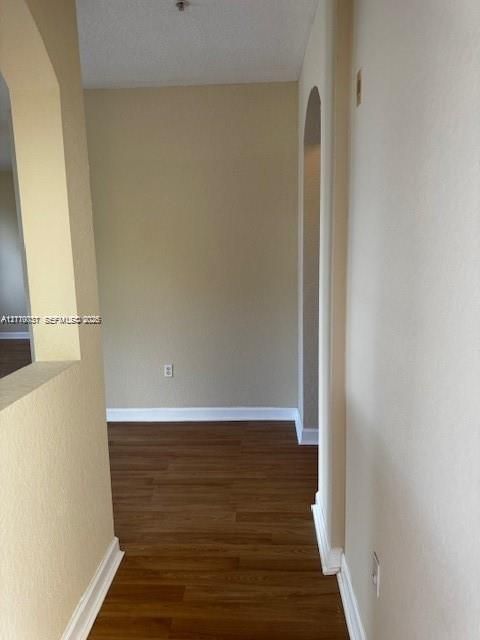 Interior space featuring wood-finish flooring and arched architectural detailing