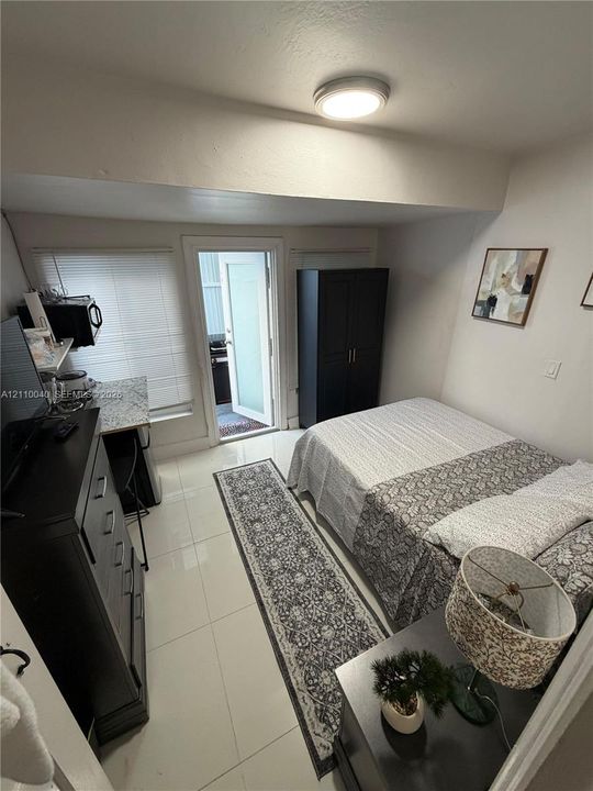 Polished tile flooring, built-in countertop surface, and exterior access door
