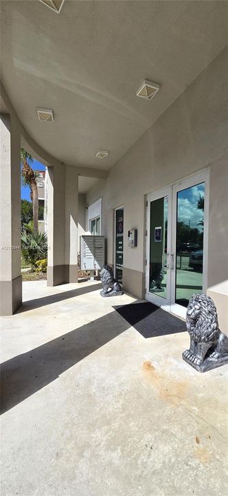 Covered entryway featuring concrete flooring, flush-mount lighting, and dual glass-pane entry doors