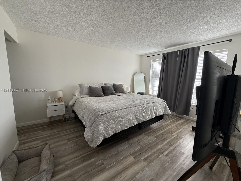 Wood-finish flooring and dual windows with curtain rod hardware