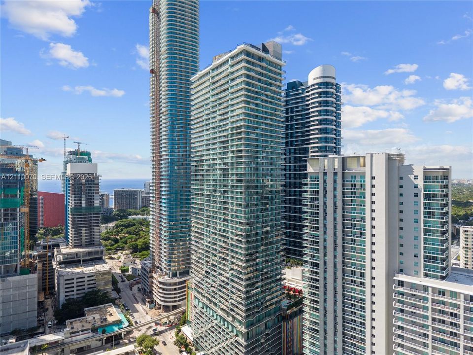 High-rise glass facade residential tower featuring floor-to-ceiling windows and private recessed balconies
