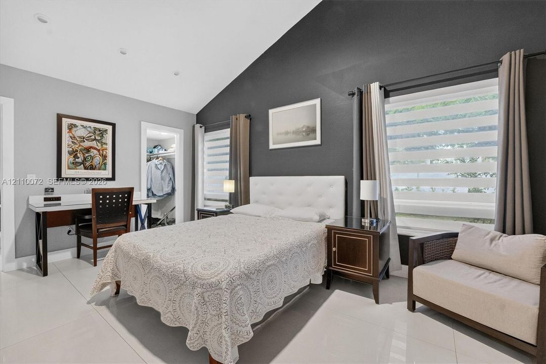 Vaulted ceilings, large-format tile flooring, and dual-tone wall finishes