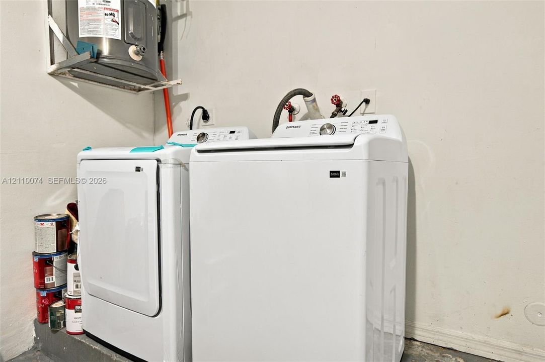 Laundry area featuring a wall-mounted water heater and dedicated appliance hookups