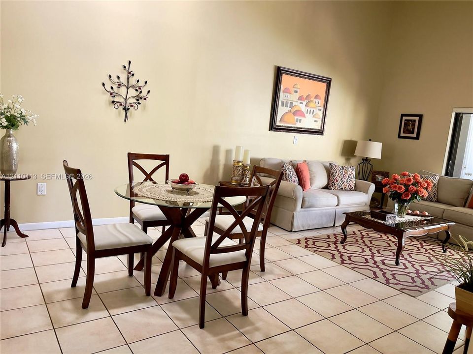 High ceilings and neutral ceramic tile flooring