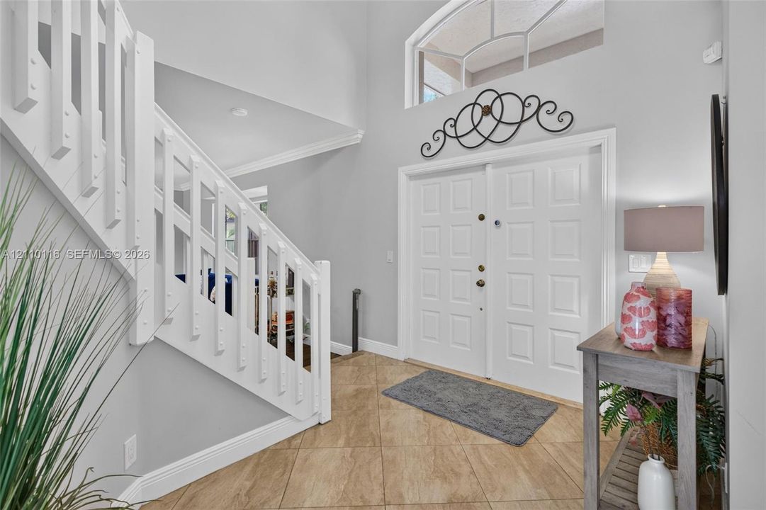 Foyer featuring high ceilings, double entry doors