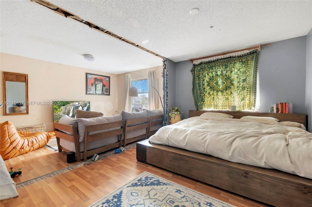 Open-concept interior featuring wood-finish flooring and windows with natural light
