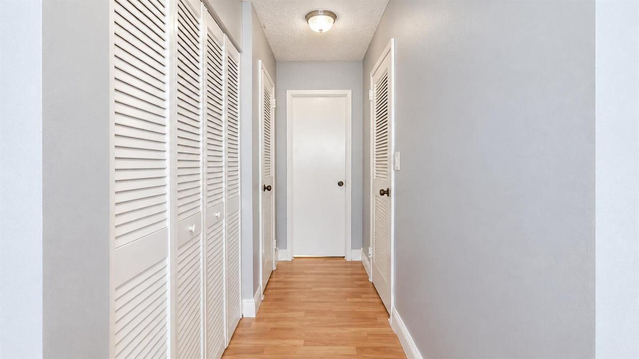 Bright Gray Hallway with Louvered Closet