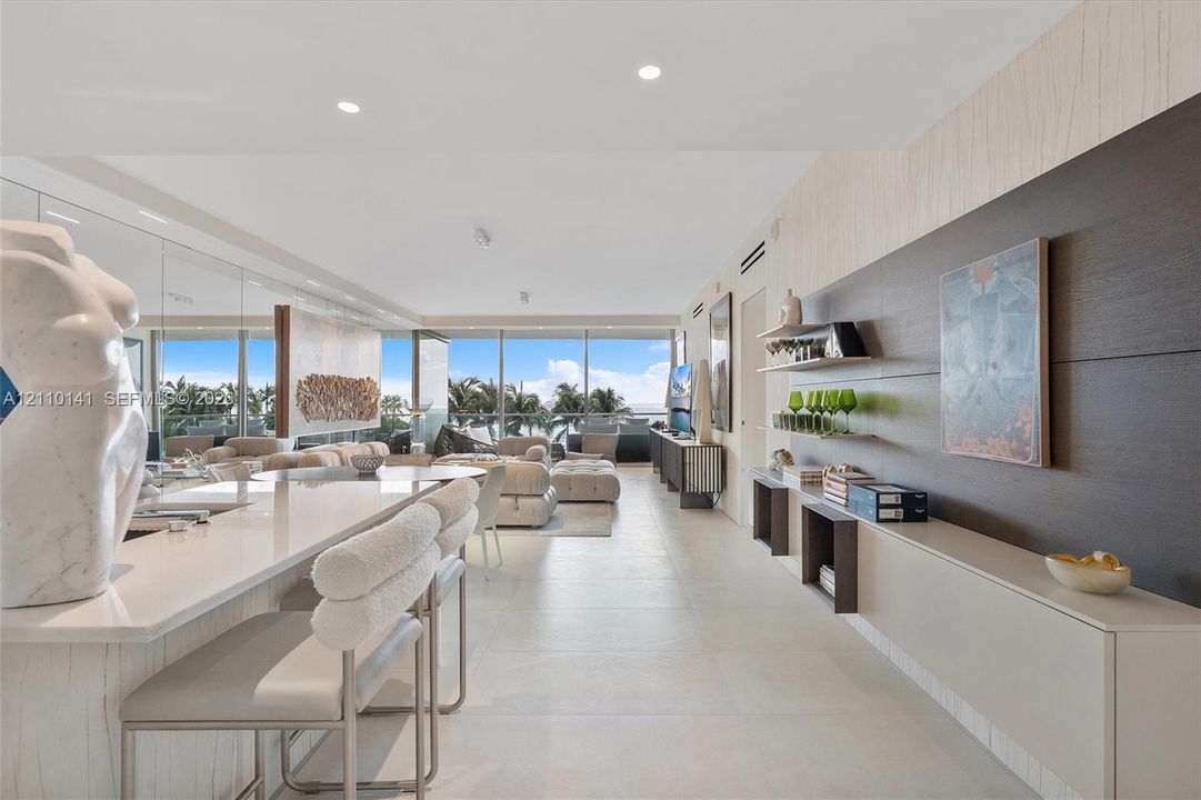 custom wall-mounted cabinetry, and a stone-surface waterfall edge island, kitchen was remodeled