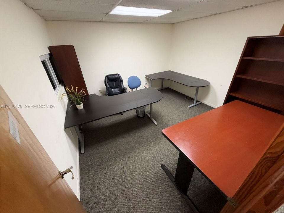 Neutral-toned interior room featuring carpeted flooring and recessed ceiling lighting