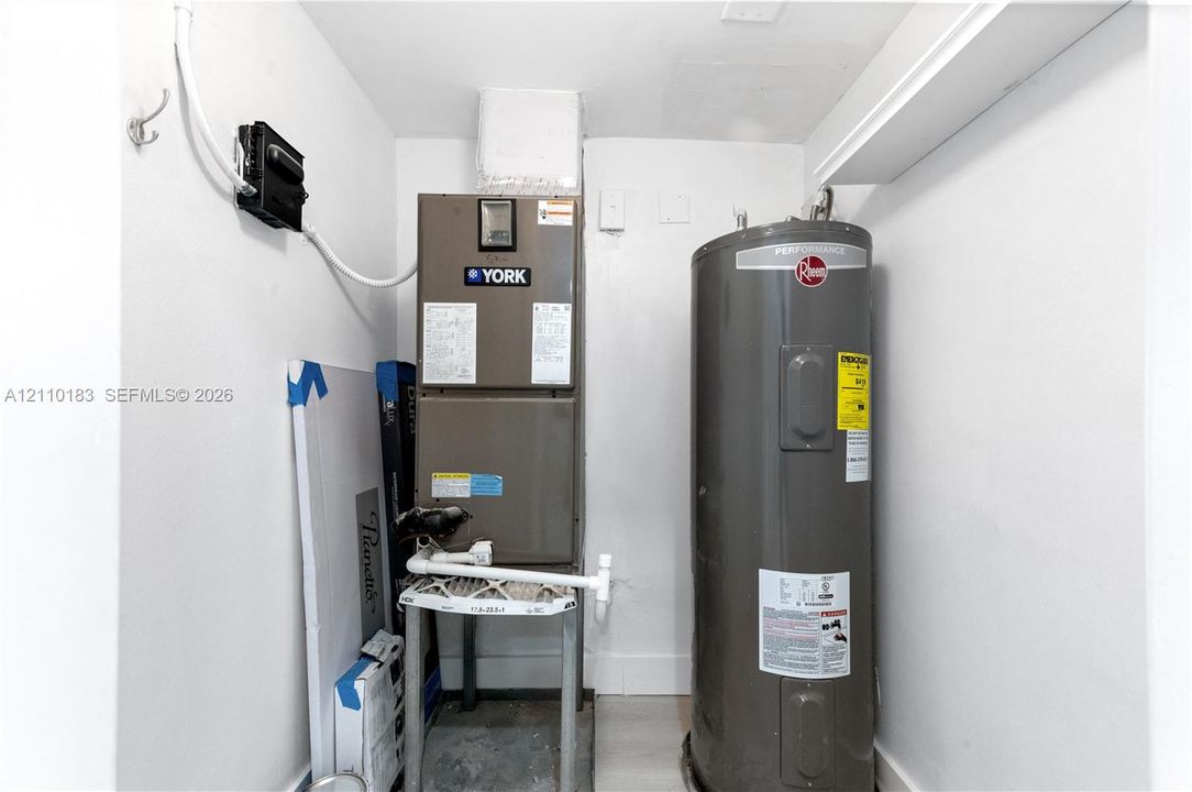 Mechanical utility space featuring a York heating unit and a Rheem Performance water heater