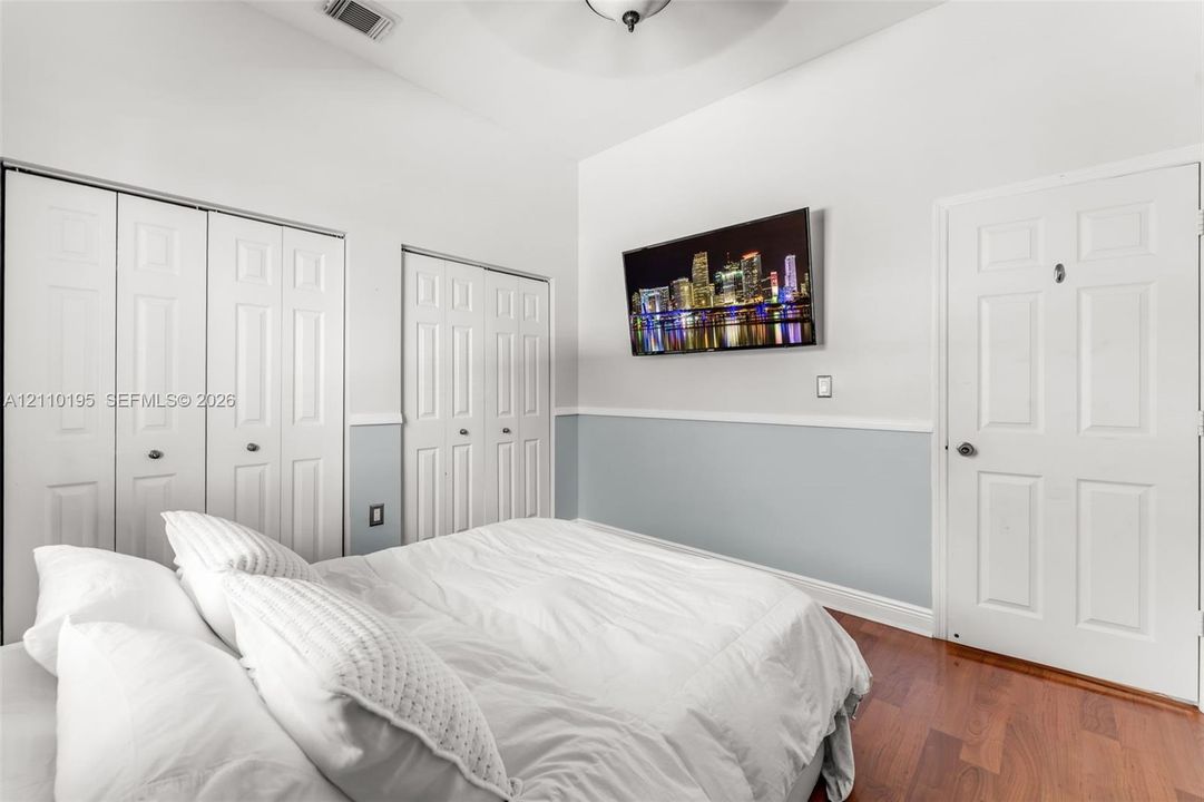 Vaulted ceiling, wood-finish flooring, two sets of bi-fold closet doors, and chair rail molding