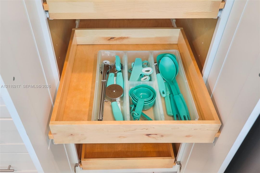 Cabinetry featuring multiple pull-out wooden storage drawers