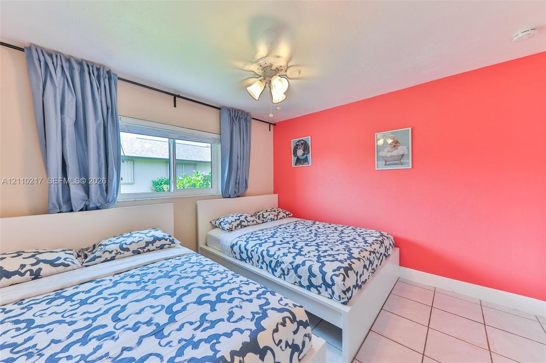 Tile flooring, white-finish ceiling fan with integrated lighting, and horizontal sliding window