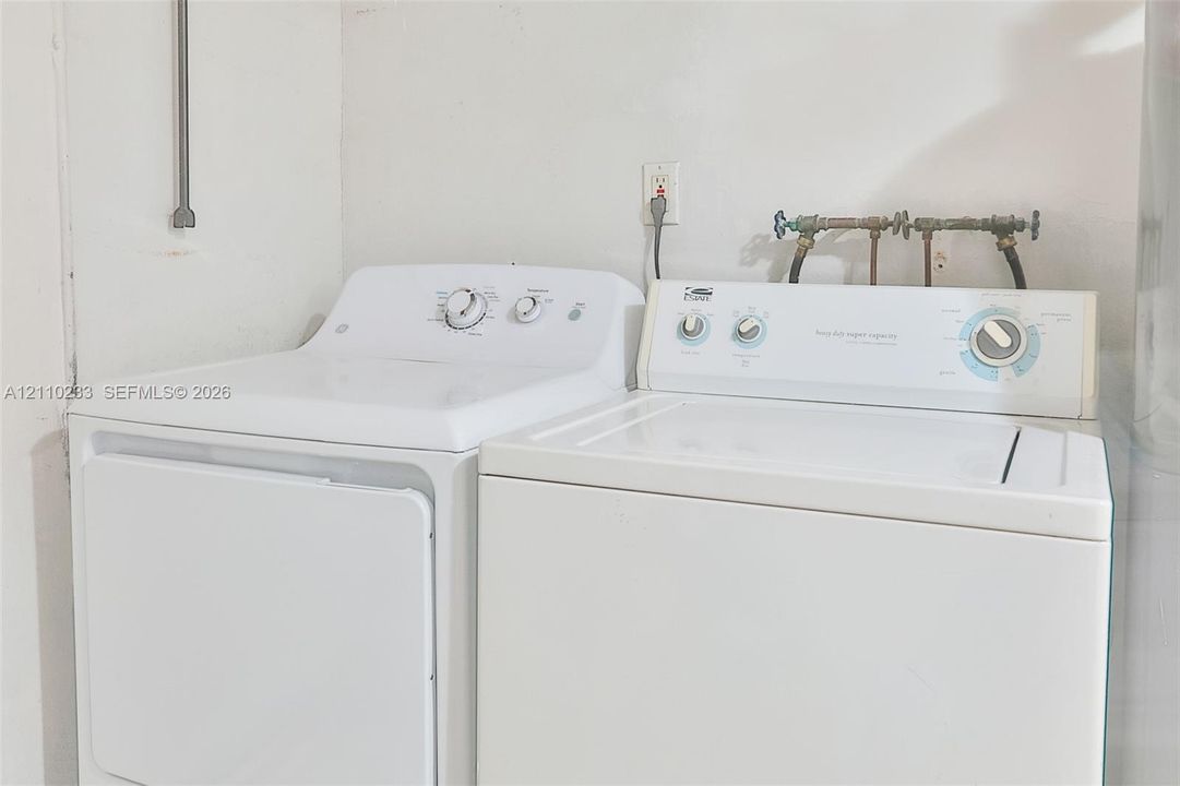Laundry area equipped with washer and dryer hookups, electrical outlets, and plumbing connections