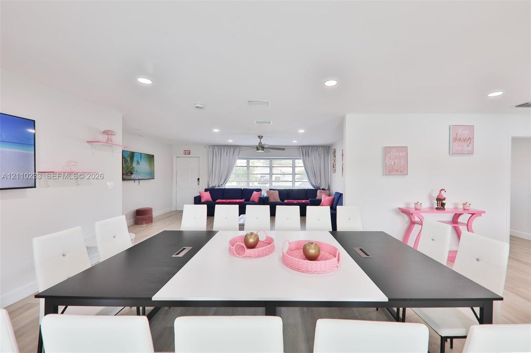 Open interior featuring recessed lighting, wood-finish flooring, and white wall-mounted shelving