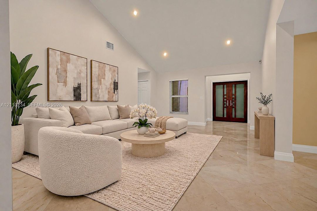 Vaulted ceilings, large-format tile flooring, recessed lighting, and double-entry doors featuring glass insets