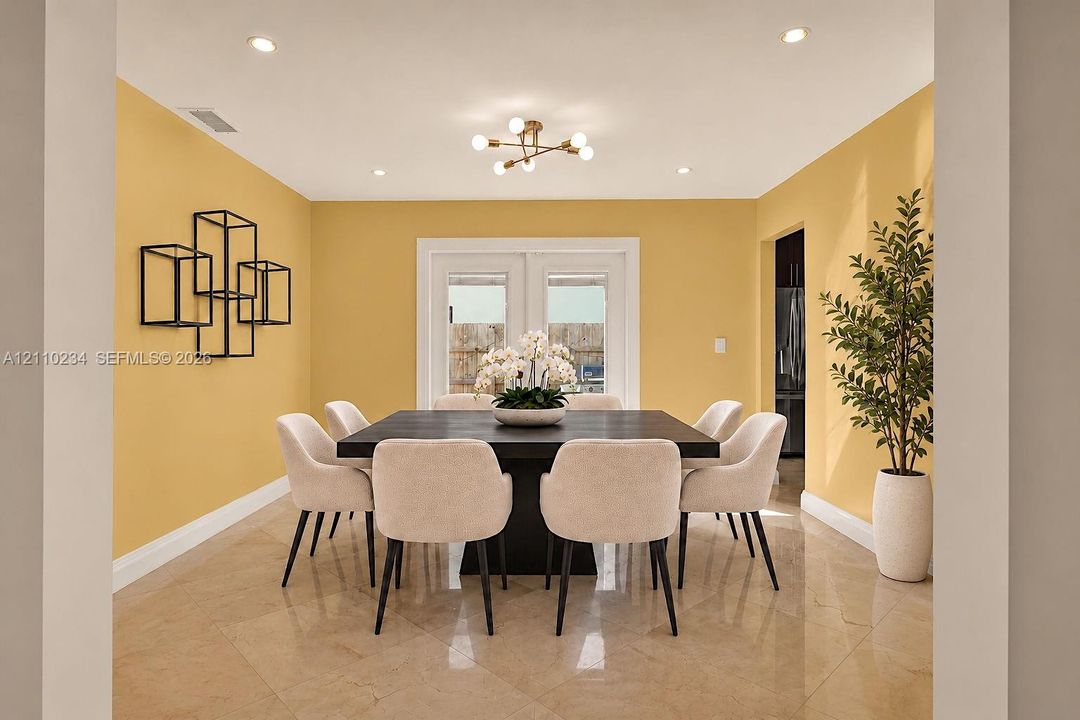 Dining area featuring polished stone-finish flooring, recessed lighting, a modern multi-arm chandelier, and glass-paneled double doors