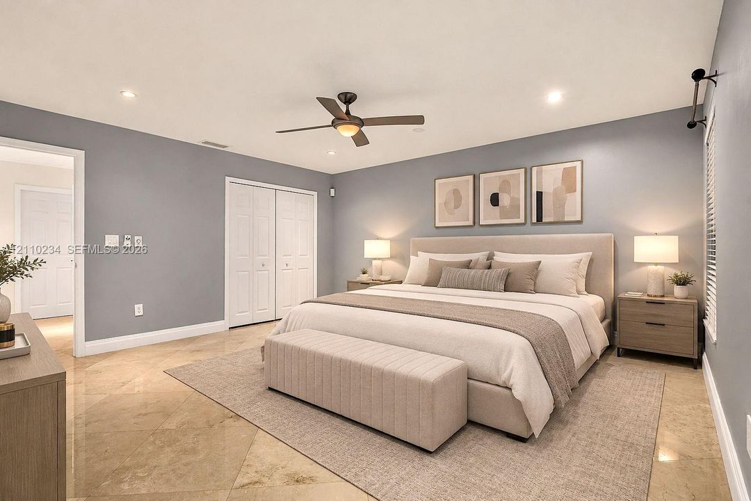 Spacious room featuring polished stone flooring, recessed lighting, a multi-blade ceiling fan, and double-door closet storage