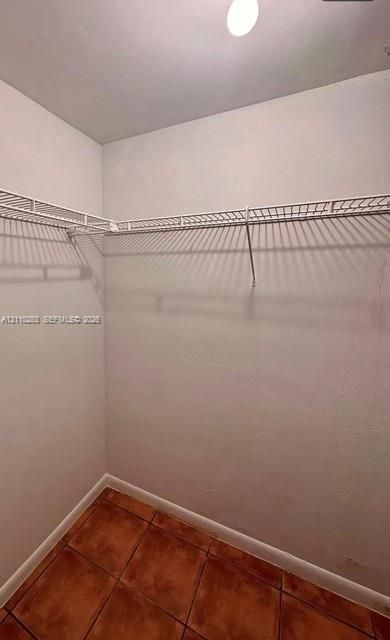 Storage area featuring tile flooring and white wire shelving