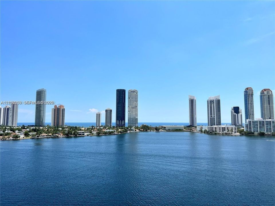 Panoramic water expanse featuring a skyline backdrop and coastal horizon