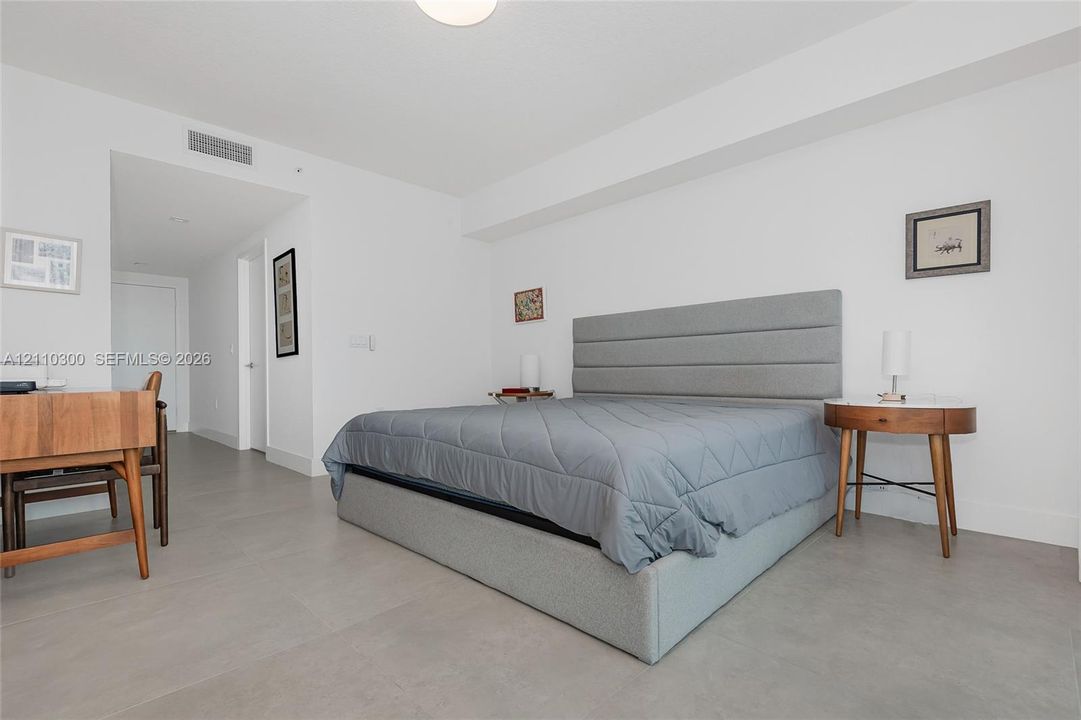 Master Bedroom. Built-in closet featuring white cabinetry, eight integrated storage drawers, adjustable shelving units, and dual metal hanging rods