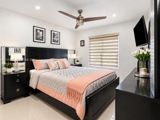 Neutral wall finish with recessed lighting, tile flooring, and a ceiling fan with integrated lighting