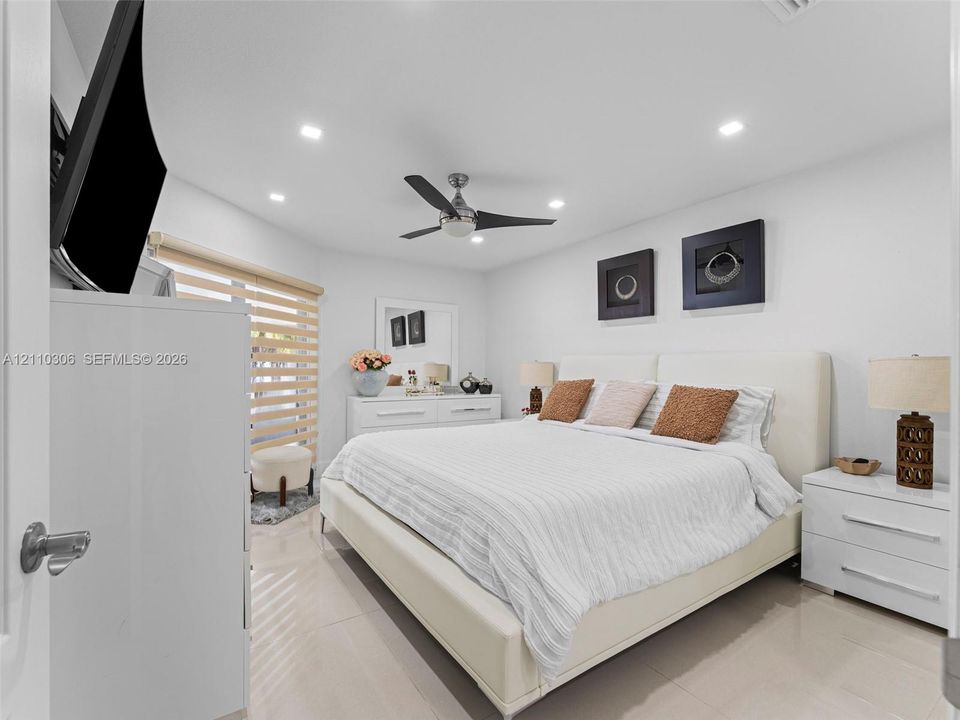 Neutral-toned flooring, recessed ceiling lighting, and a modern ceiling fan with integrated light fixture
