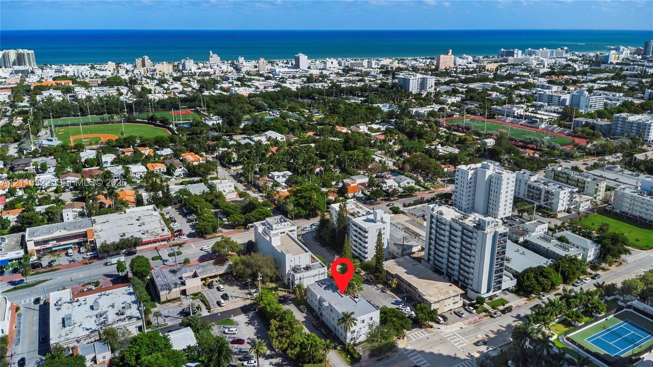 Aerial perspective of a multi-story building featuring a flat roof and proximity to coastal waterfront areas