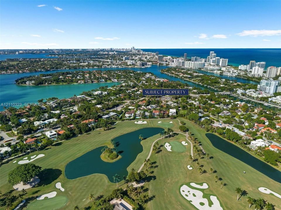 Aerial perspective featuring a waterfront setting, proximity to coastal waterways, and expansive golf course grounds