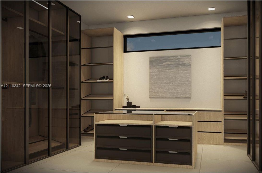Custom cabinetry featuring wood-finish shelving, glass-front wardrobe enclosures, a central island with a glass top and matte-finish drawers, and recessed lighting, accented by a horizontal clerestory window