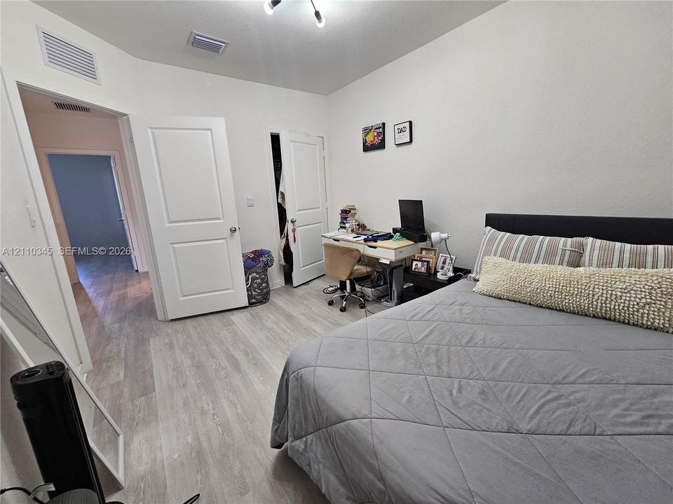 Interior space featuring wood-finish flooring, two-panel interior doors, and a built-in closet